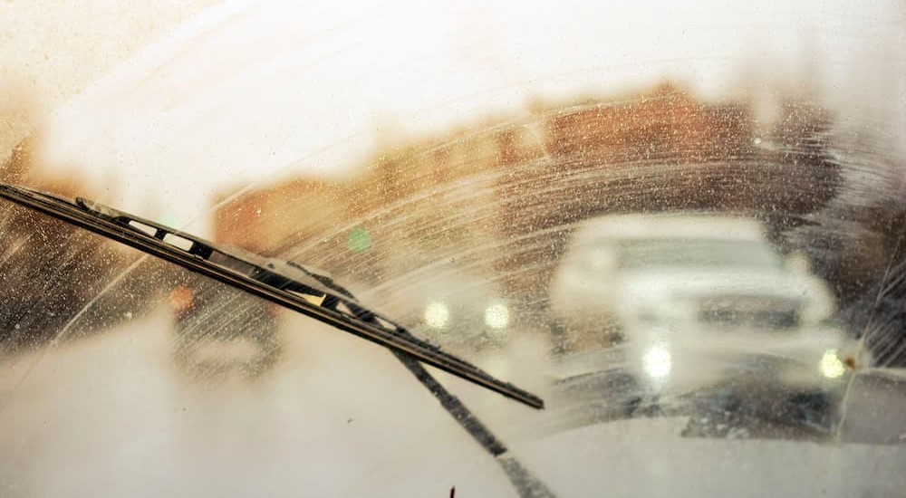 A streaky windshield is shown demonstrating the importance of windshield wiper replacement.