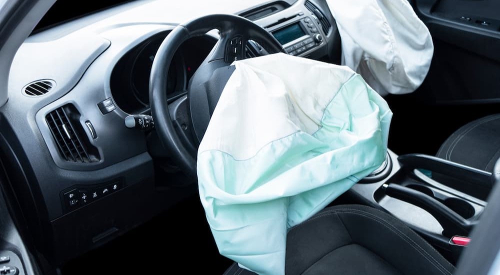 Two airbags are shown deployed in a vehicle.