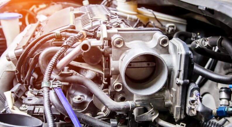 A throttle body on a clean-looking engine.