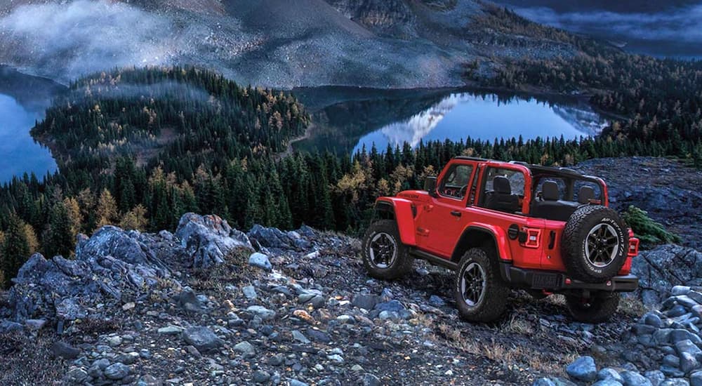 A red 2020 Jeep Wrangler Rubicon is shown parked near a cliff.