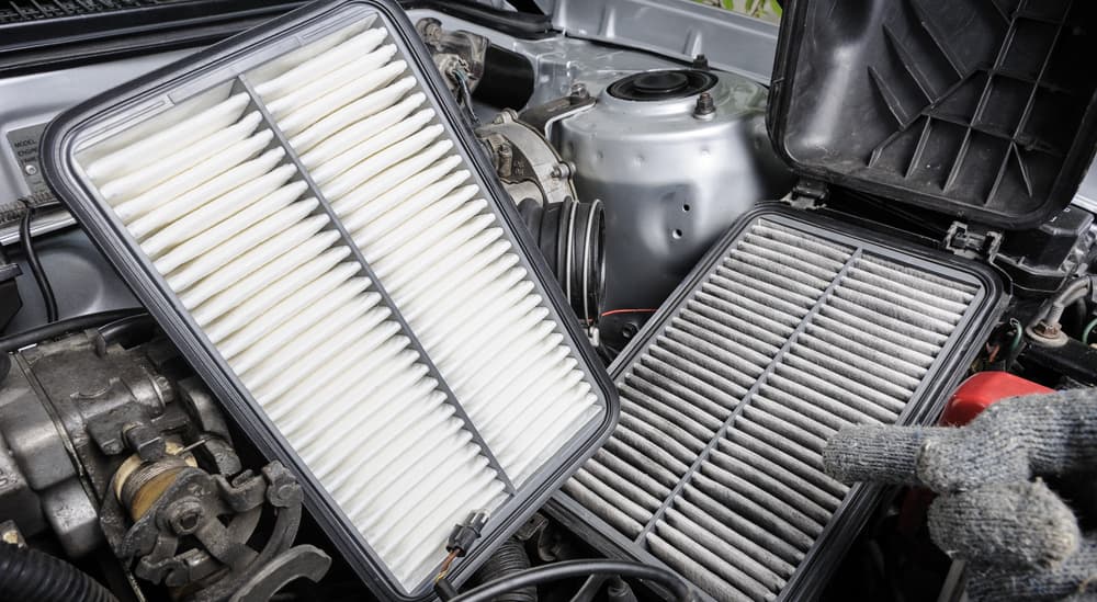 A pair of car air filters are shown in an engine.