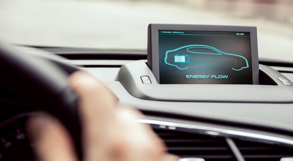 The information screen in a hybrid vehicle displaying energy flow information. 