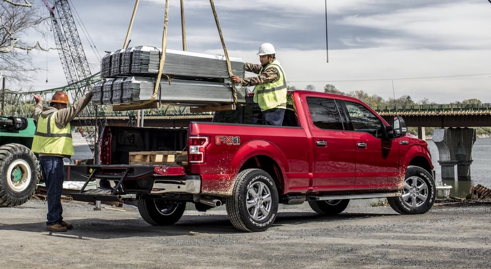 A red 2020 Ford F-150 FX4 is shown parked on a construction site.