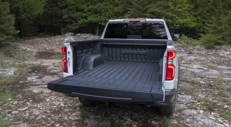 A rear view of the open tailgate of a white 2024 Chevy Silverado 1500 ZR2.