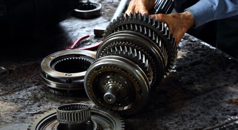 A mechanic is shown working on a transmission at a transmission shop in Rochester.