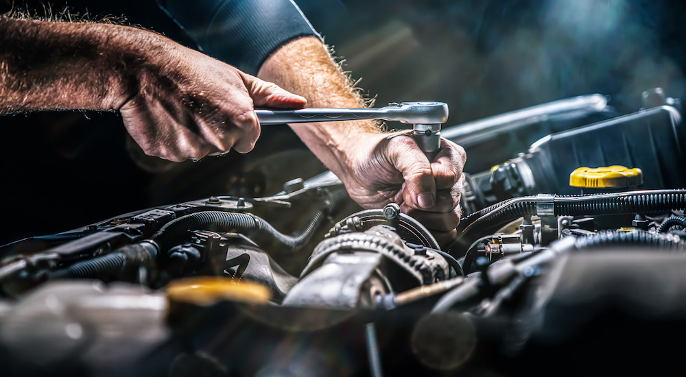 A mechanic performing maintenance on an engine block.