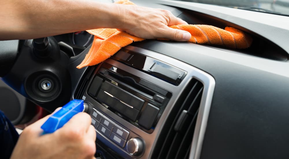 A person is shown wiping down the vent on a dash.