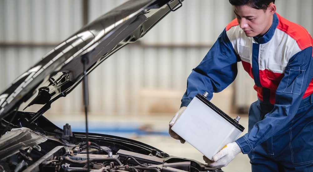 A mechanic is shown performing a car battery replacement near Mason.