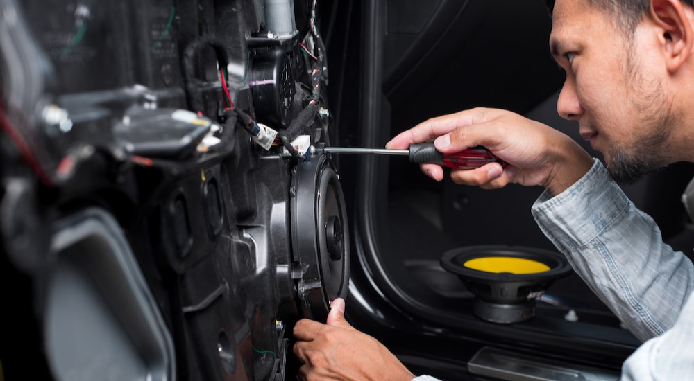 A technician is shown installing a speaker.