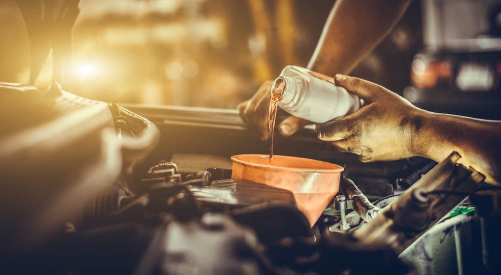 Replacing the oil in an engine after an oil change.