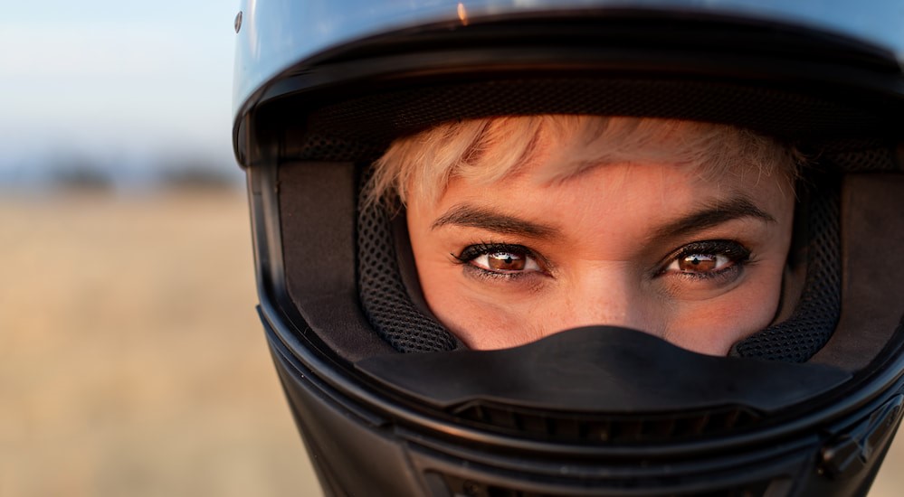 A close-up of a biker wearing a helmet is shown.