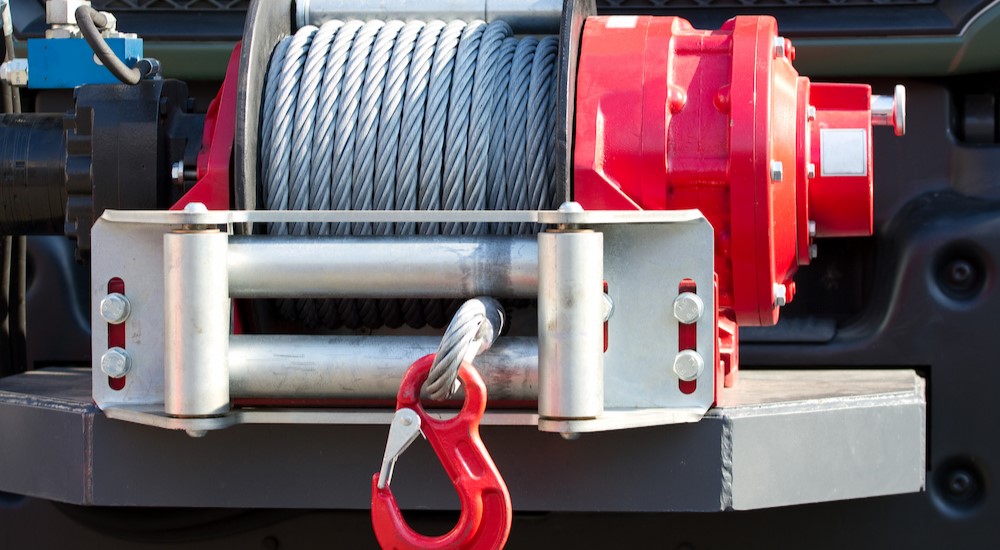 A red tow winch is shown on a vehicle.