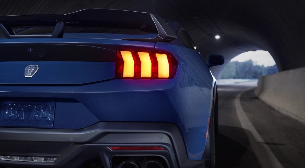 A close up shows the passenger side taillight on a blue 2025 Ford Mustang Dark Horse