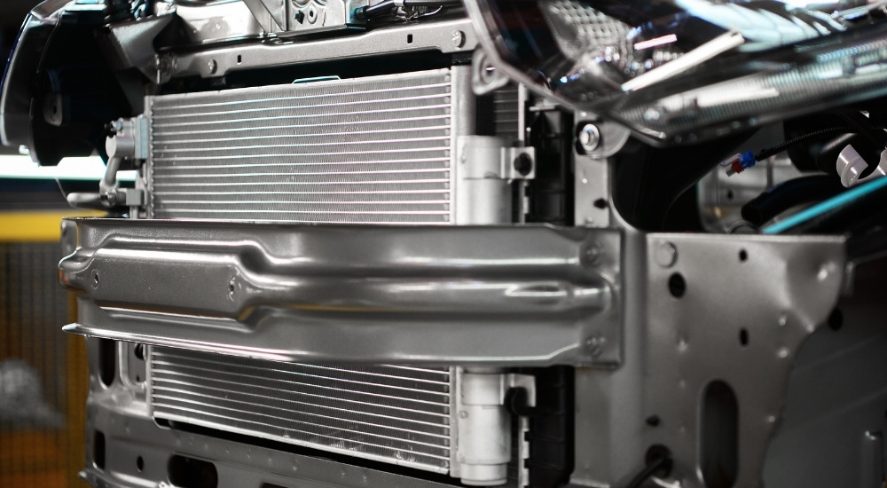 A car's radiator is shown in close-up.