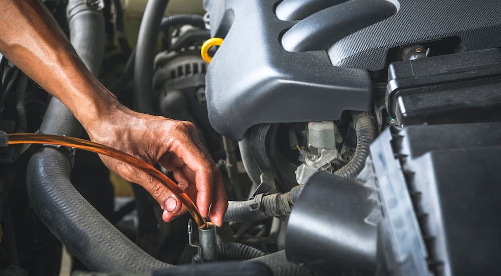 A technician is shown replacing CVT fluid at a transmission shop near me.