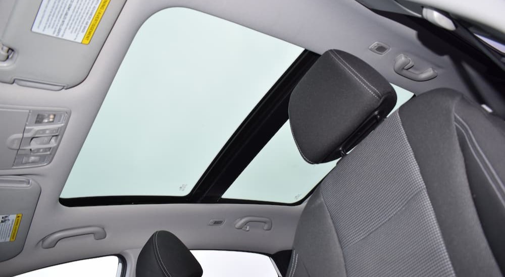 A moonroof is shown from the interior of a vehicle.