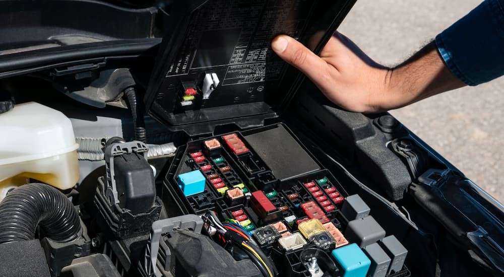 A fuse box is shown in a vehicle.