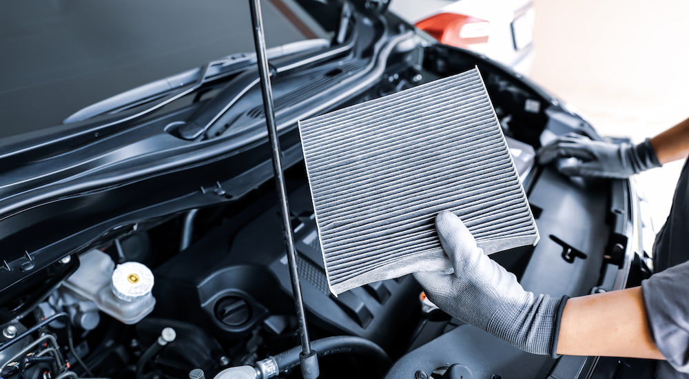 An engine air filter being removed for inspection.