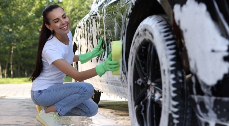 Person cleaning a car.