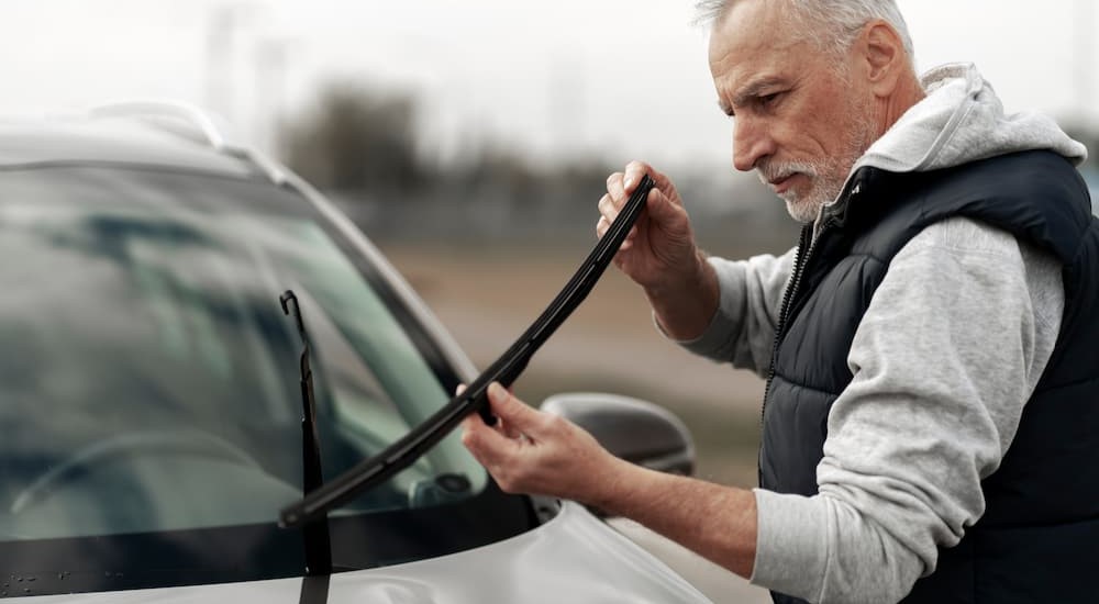 A person inspecting wiper blades.