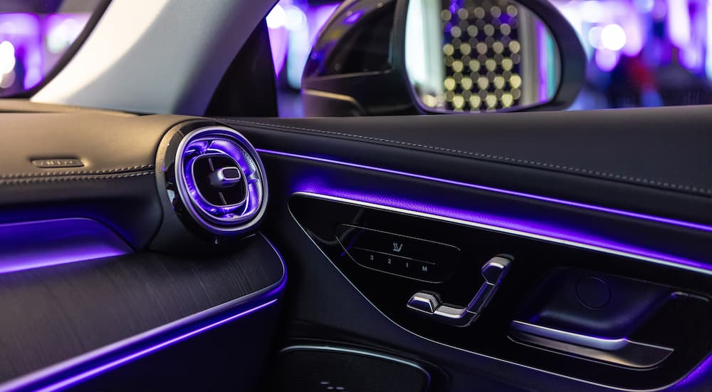 Purple ambient lighting in the door and dash of a vehicle