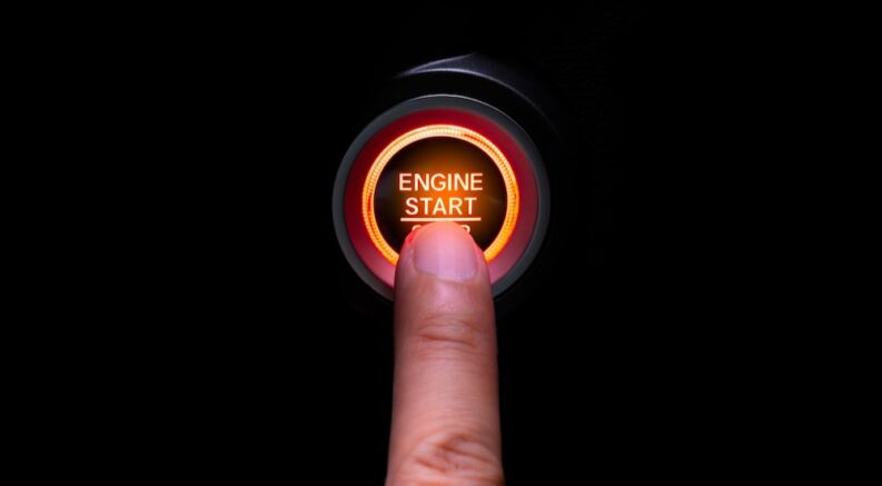 A finger pushing an "Auto Start/Stop Systems" button.