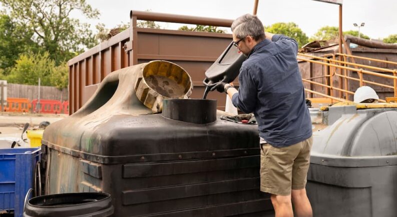 A person recycling oil.