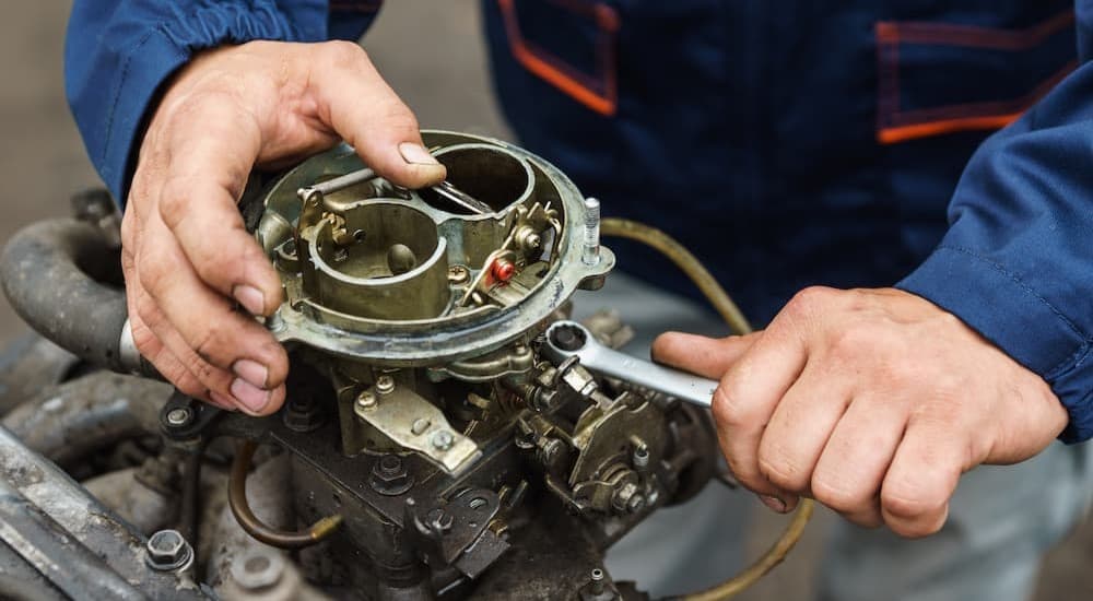 A mechanic working on a carburetor.