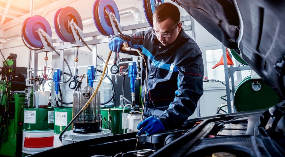 A technician changing fluids.
