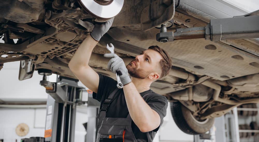 A mechanic working on replacing a brake rotor