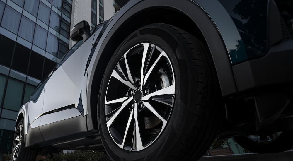 A rim and tire on a black car