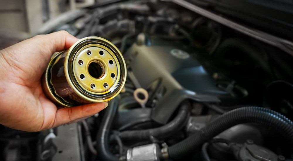A technician holding an oil filter.
