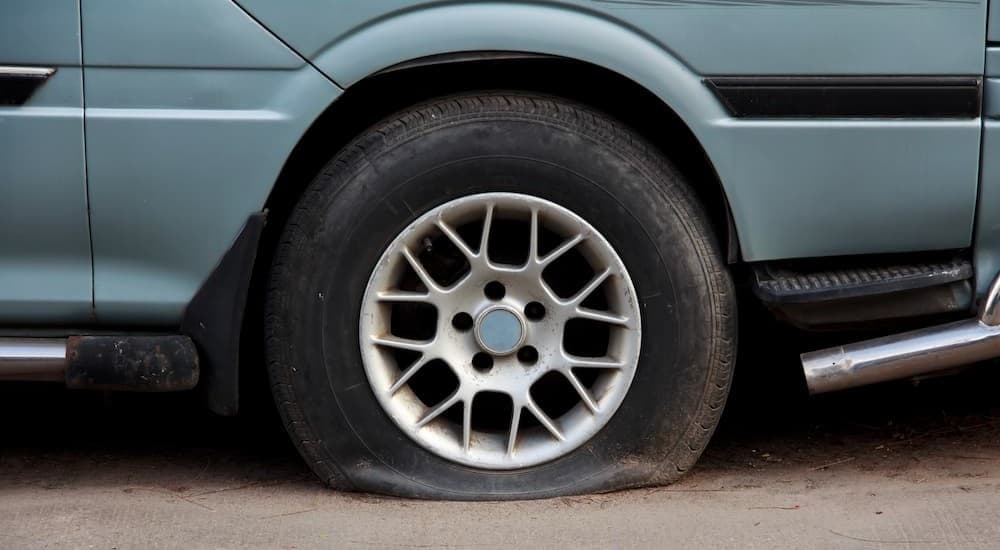 A blue vehicle with ow tire pressure.