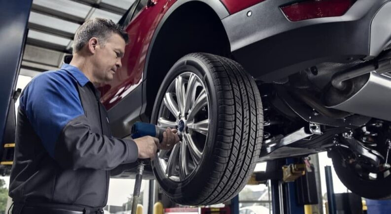 A technician changing a tire.