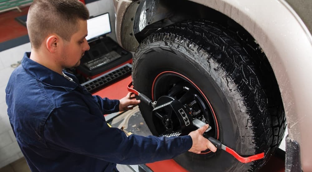 A technician performing a tire alignment.